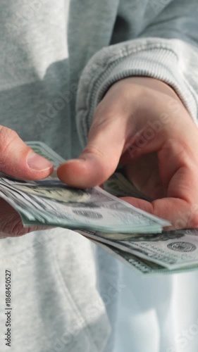 Financing and investments.
Cash savings and counting money in hands.
American dollars in a man's hands