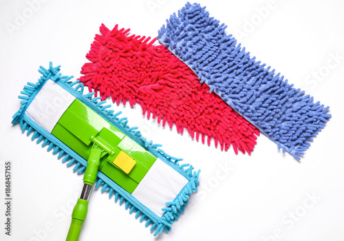 Schilderij op canvas Green plastic mop with shaggy rags on white background