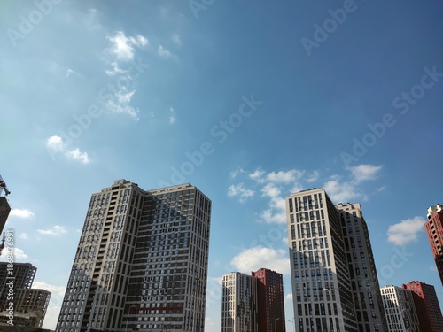 Contemporary buildings captured from below on sky background