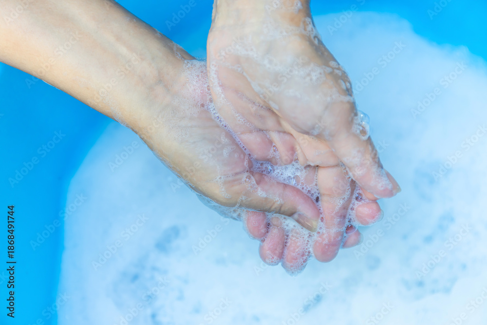 Fototapeta premium Hands Washing with Soap and Foam in Clean Water, Close-up, Wash hands hygiene, sanitation, disease prevention, and sustainable water use for health