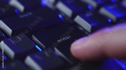 Close up of a hand rapidly pressing the enter key on a keyboard, showing urgency and pressure during computer work. Captures a decisive moment in a digital environment.