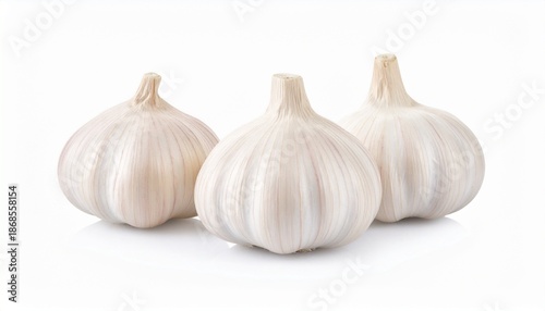 Three whole garlic bulbs side by side on white background, fresh and intact with papery skin.