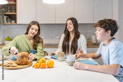 Family siblings enjoying breakfast together in kitchen