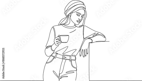 Woman relaxing with coffee in hand, standing and enjoying leisure time