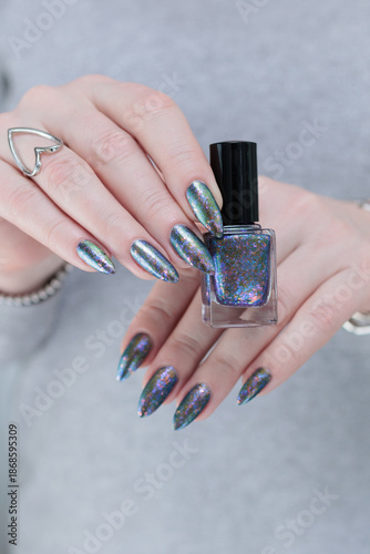 Female hand with long nails and a gray silver manicure