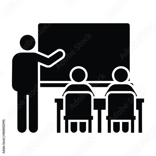 Teacher pointing at blackboard with students sitting at desks in classroom education learning