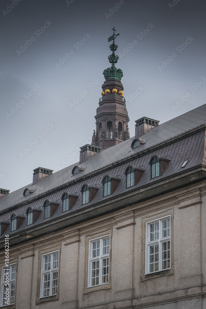 Fototapeta premium Crowned tower and statues atop historic Danish building