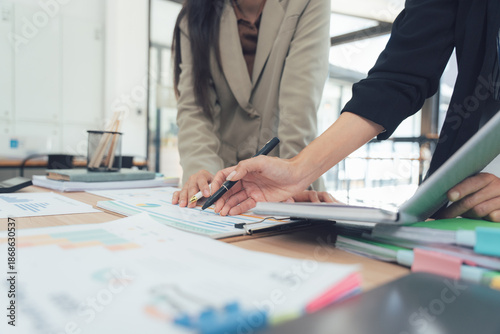 Foto Business meeting in office: A professional business meeting in an office setting, hands gesturing and discussing the data on desk