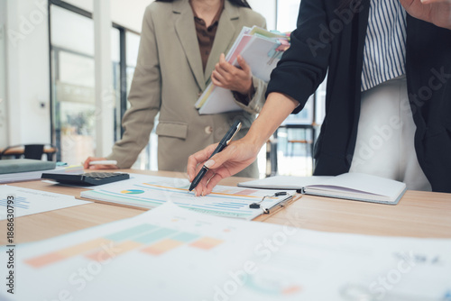 Bild auf Leinwand Business Analysis: A focused moment in a collaborative workspace where two professionals engage in strategic planning, with charts and documents providing insights for optimal business success