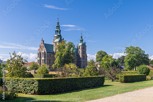 Rosenborg Castle in Copenhagen, Denmark, with green copper spires and surrounding garden and lush lawns