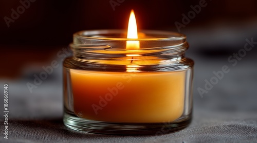 Traditional memorial candle lit during Yahrzeit observance in a simple setting