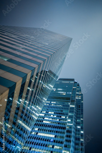 Modern glass skyscrapers rising toward the sky in Hong Kong, China. Abstract view of corporate architecture symbolizing business growth, finance and global economy