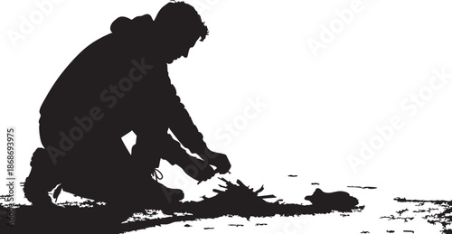 Silhouette of a person kneeling and whisking something in a bowl on a countertop
