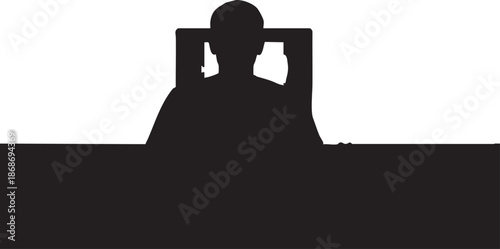 Silhouette of a person sitting at a desk with a laptop and a cat on their lap 1
