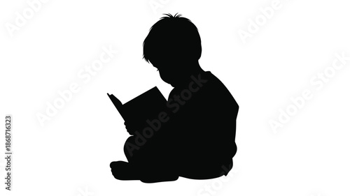 A child engrossed in reading a book depicted as a dark silhouette