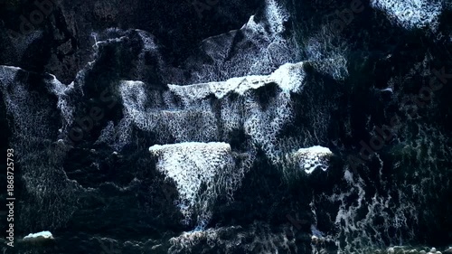 90 degrees aerial view Atlantic ocean waves crashing on the coast. Slow motion 4K