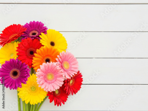 Bright Mixed Gerbera Daisies Bouquet Against White Wooden Background 1
