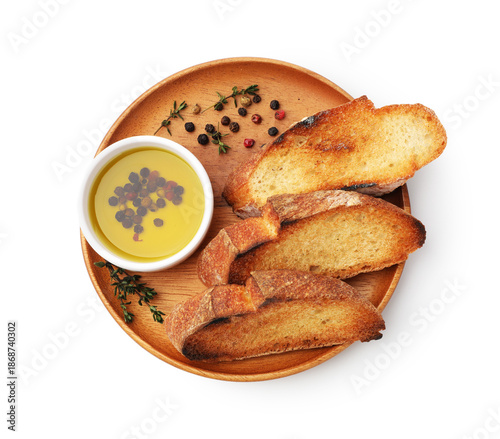 Fotografie Slices of baguette, olive oil and spices isolated on white, top view