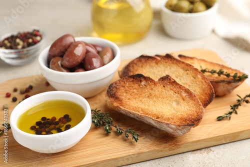 Wallpaper Mural Slices of baguette, oil, spices and olives on light table, closeup Torontodigital.ca