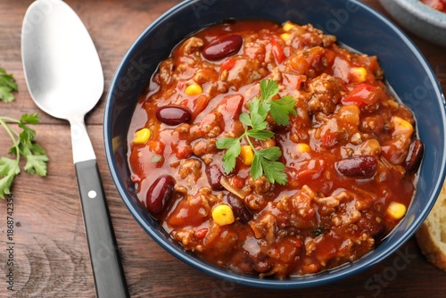 Fotografi Delicious chili con carne served on wooden table, closeup