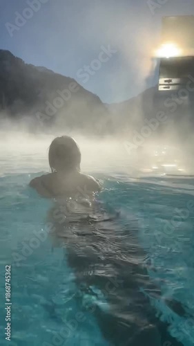 Woman in swimming pool outdoors in winter
