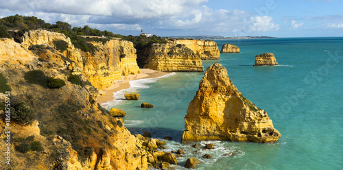 Girl traveler taking selfie in Cliffside ocean view Arcos Naturais da Praia da Marinha Lagoa, Algarve