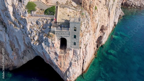  castle nestled on vertical cliffs above serene mediterranean coves near italy. Porto Flavia. 