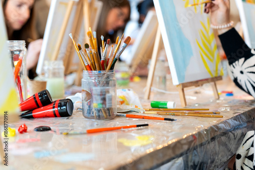 People enjoying painting art class with brushes