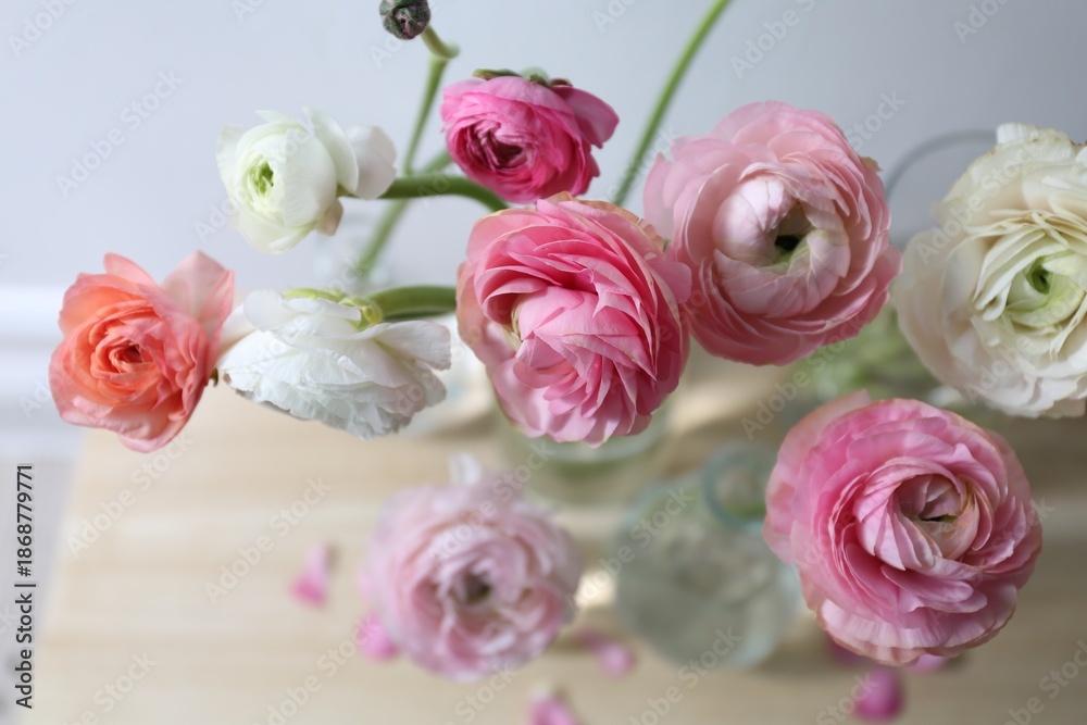 Fototapeta premium Beautiful fresh ranunculus flowers on table, closeup view