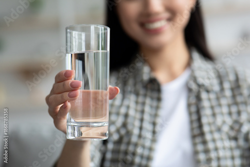 Fotografie Glass of fresh spring water in young woman hand, closeup