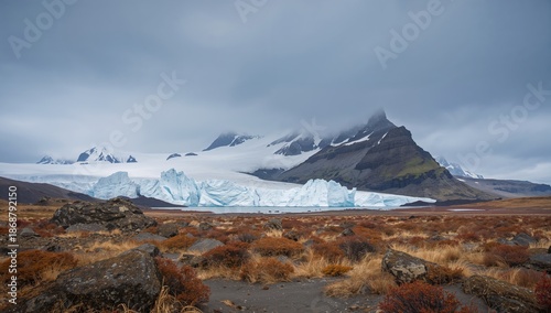 Mountains and Ice Formations Stand Under Cloudy Skies in a Landscape Near a G...