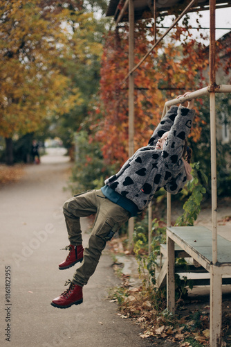 little girl walking in autumn park