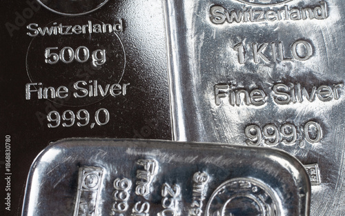 Close-up of Swiss fine silver bars showing purity marks and weight stamps. Shiny bullion texture highlights precious metal investment, wealth, finance, and secure asset concepts.