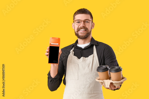 Male barista with payment t...