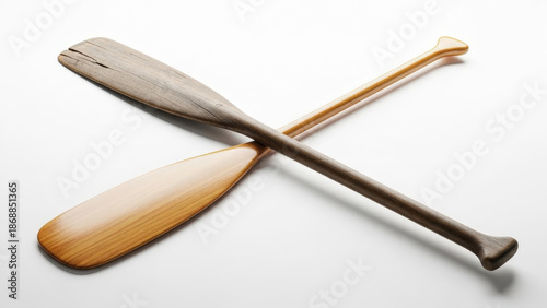 Two wooden oars crossed on a white background isolated on white background