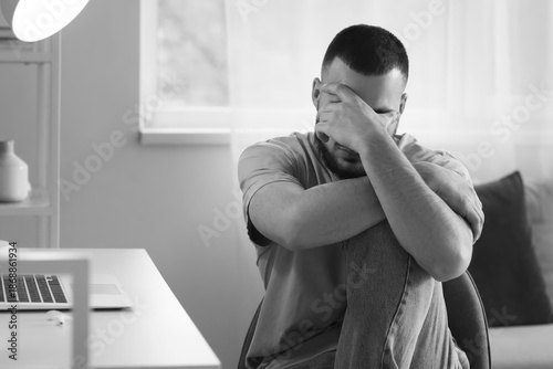 Depressed young man sitting...