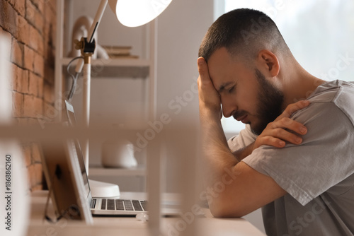 Sad young man sitting near ...