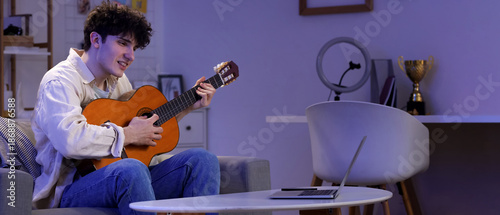 Male student playing guitar...
