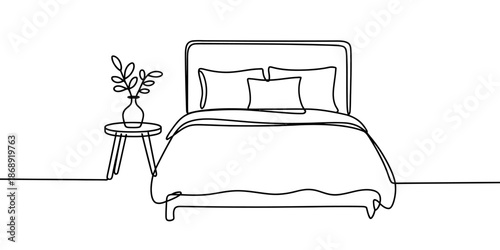 A minimalist bedroom with a simple bed and a small table with a plant