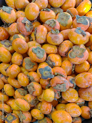 Canvas Print Fresh persimmons at a market stand