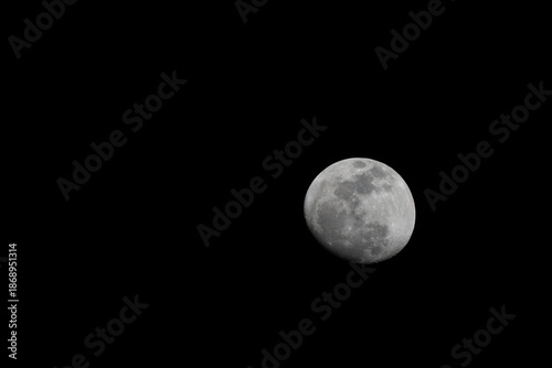 Close-up telephoto shot of a bright Full Moon isolated against a pitch-black sky. The image reveals sharp details of the lunar surface and craters, with ample space for text.
