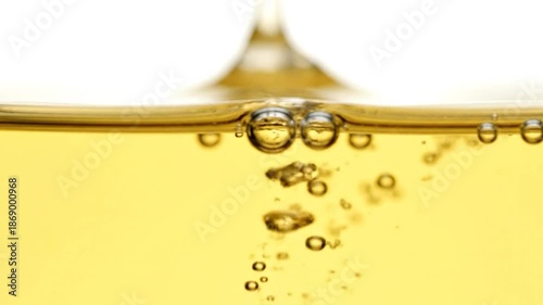 Close up of yellow liquid with many bubbles rising