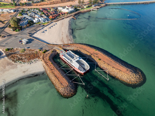 Modern ferry boat at anchor in protective rock breakwalls