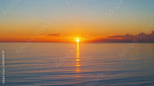 Wallpaper Mural Timelapse of sunset over ocean with vibrant hues, capturing the serene beauty as the sun sets below the horizon. Torontodigital.ca