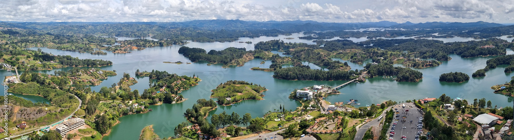 Fototapeta premium Panoramic view of Guatape lake area, (Penol) Colombia, South America cloudy day amazing tree area in middle of lake 4