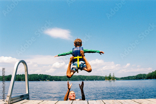 Summer in Maine: Boy jumps into lake off a dock