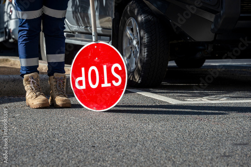 Canvastavla A traffic control person with a stop sign, with safety boots and work trousers