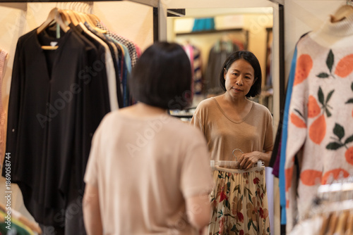 Wallpaper Mural Asian woman choosing clothes in a local boutique shop Torontodigital.ca
