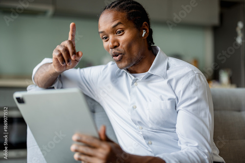 Confident Professional Man On Video Call Points Finger Up