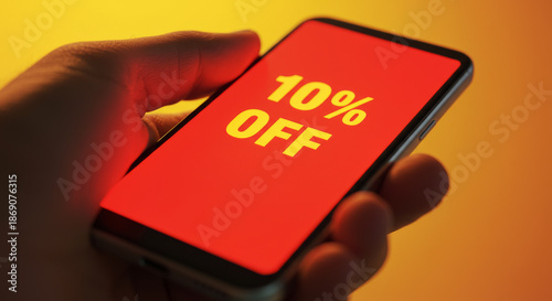 10% Off: A hand holding smartphone showcasing the discount offer of 10% off, capturing the essence of a deal.
